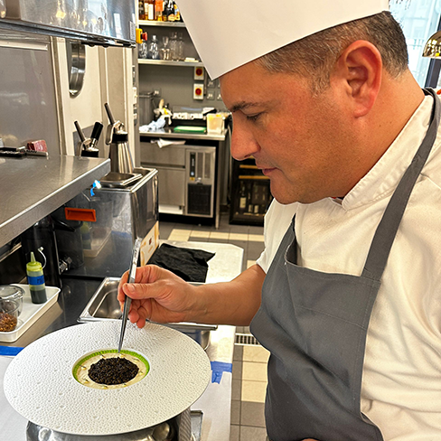 Babak is plating Duck Jelly with Smoked Sturgeon and Special Caviar